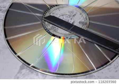 A CD with radial scratches made with a cutter 118203560