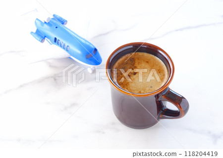 Image of a passenger plane waiting to take off and freshly brewed coffee, planning a trip 118204419