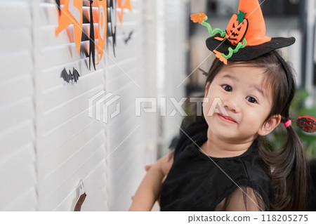 Little girl in Halloween costume smiling at home Little girl in Halloween costume smiling at home 118205275