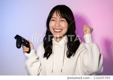 Portrait of a young woman wearing a white hoodie (game, controller) Portrait of a young woman wearing a white hoodie (game, controller) 118205705