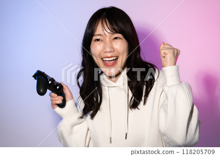 Portrait of a young woman wearing a white hoodie (game, controller) Portrait of a young woman wearing a white hoodie (game, controller) 118205709