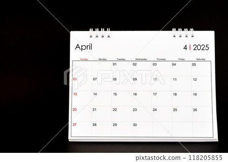 Desk Calendar for April 2025. Desktop calendar on a black background. 118205855