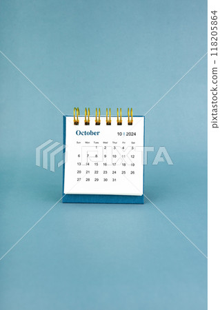 October 2024 white desk calendar on blue background. October 2024 white desk calendar on blue background. 118205864