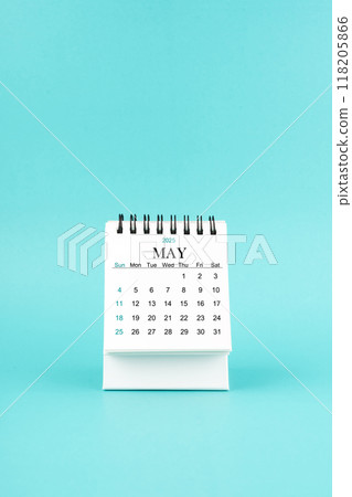 May 2025 white desk calendar on blue background. 118205866