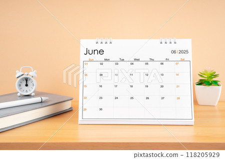 June 2025, Monthly desk calendar for 2025 year on wooden table. June 2025, Monthly desk calendar for 2025 year on wooden table. 118205929