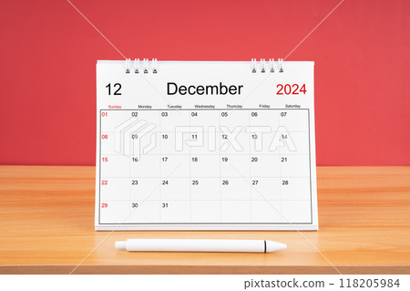 December monthly desk calendar for 2024 year and pen on the wooden table. 118205984