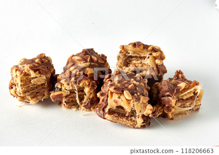 Wafer caramel bar with nuts and chocolate glaze broken into pieces Wafer caramel bar with nuts and chocolate glaze broken into pieces 118206663