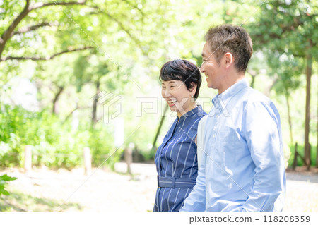 Senior couple taking a walk, fresh greenery Senior couple taking a walk, fresh greenery 118208359