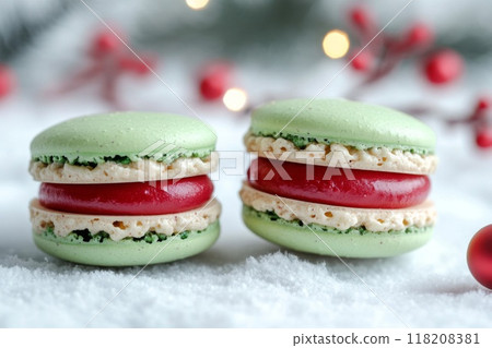 Two Green Macarons with Red Filling on Snowy Surface Two Green Macarons with Red Filling on Snowy Surface 118208381