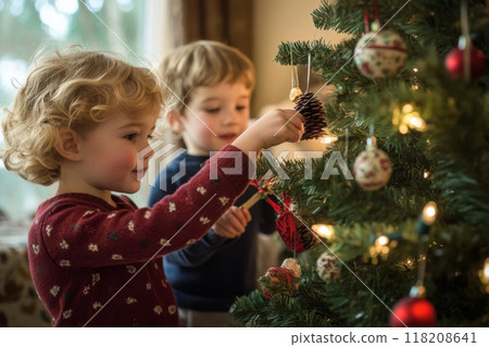 A Little Girl Decorates a Christmas Tree with Her Brother 118208641
