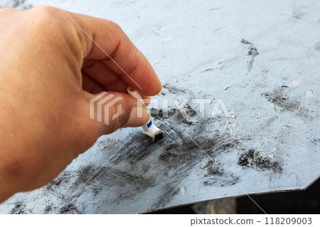 A Skilled Artists Hand Delicately Applying Charcoal to the Canvas with Careful Precision A Skilled Artists Hand Delicately Applying Charcoal to the Canvas with Careful Precision 118209003