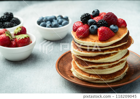 Stack of homemade american pancakes with berries . Top view 118209045