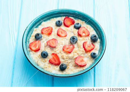Homemade breakfast . Oatmeal with milk and berries . Top view Homemade breakfast . Oatmeal with milk and berries . Top view 118209067