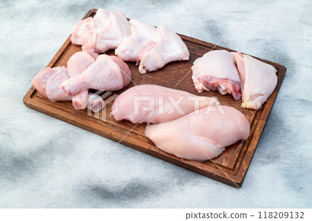 Raw mixed chicken meat parts for cooking on rustic background Raw mixed chicken meat parts for cooking on rustic background 118209132
