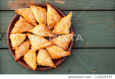 Homemade triangle puff pastry with meat on rustic background . Samosa Homemade triangle puff pastry with meat on rustic background . Samosa 118209147