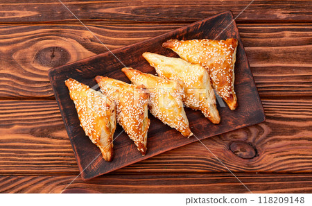 Homemade triangle puff pastry with meat on rustic background . Samosa Homemade triangle puff pastry with meat on rustic background . Samosa 118209148