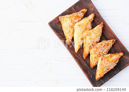 Homemade triangle puff pastry with meat on rustic background . Samosa 118209149