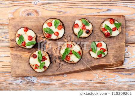 Italian mini pizza . Aubergine (eggplant ) with mozzarella cheese and basil . On rustic background 118209201
