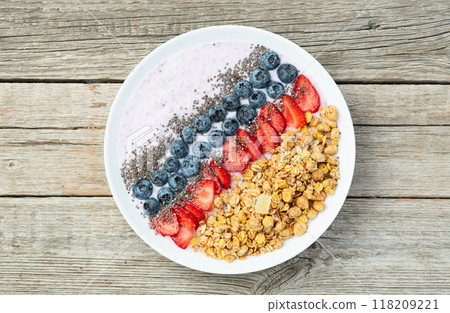 Healthy breakfast . Yogurt with berries ( strawberry , raspberry , blueberry , blackberry ) , granola and chia seeds . Top view 118209221
