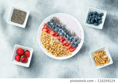 Healthy breakfast . Yogurt with berries ( strawberry , raspberry , blueberry , blackberry ) , granola and chia seeds . Top view 118209224