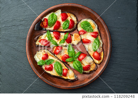 Italian mini pizza . Aubergine (eggplant ) with mozzarella cheese and basil . On rustic background 118209248