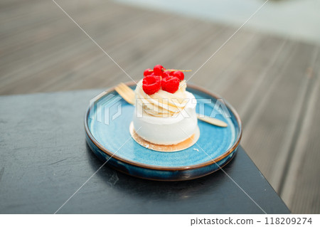 Beautiful tasty white cake with white cream and fresh raspberries at cafe. Sweet summer dieting dessert. High quality FullHD footage 118209274