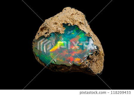 macro mineral stone rare and beautiful opals on a black background 118209433