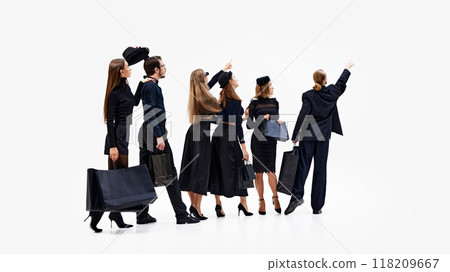 Group stands at attention, all looking forward and pointing as if they've spotted something of great interest against white studio background. 118209667