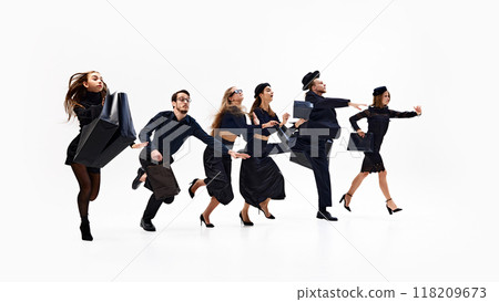 Group of chic shopper dressed total-black looks, sprinting enthusiastically, with bags in hand, against white studio background. 118209673