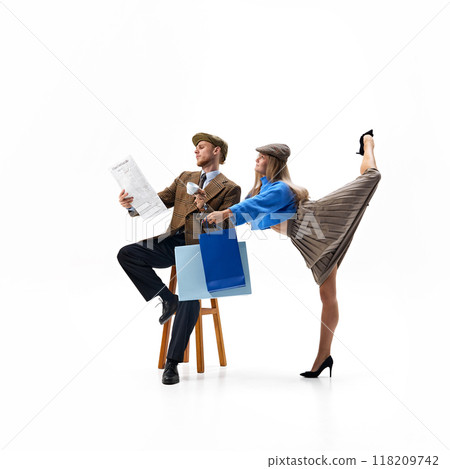 Young stylish dressed couple balances reading news and successful shopping day against white studio background. Young stylish dressed couple balances reading news and successful shopping day against white studio background. 118209742