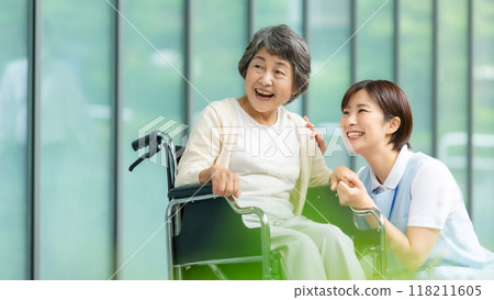 Wheelchair caregiver and senior woman 118211605