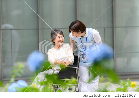 Wheelchair caregiver and senior woman 118211608