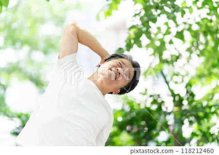 Senior man stretching in the park Senior man stretching in the park 118212460