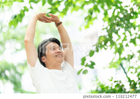 Senior man stretching in the park Senior man stretching in the park 118212477