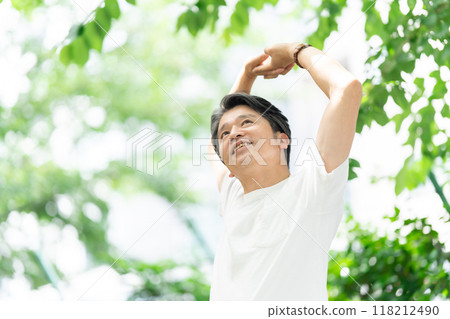Senior man stretching in the park Senior man stretching in the park 118212490