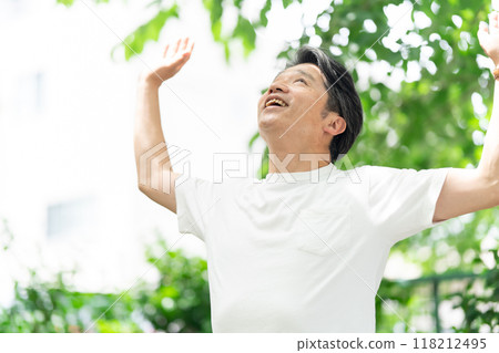 Senior man stretching in the park 118212495