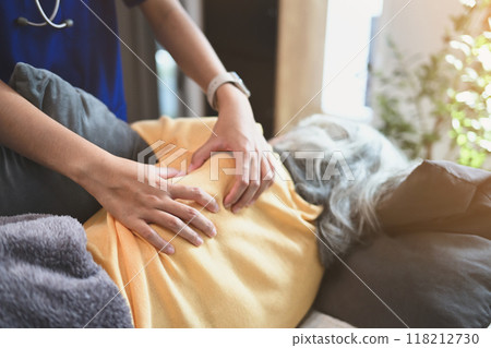 Physiotherapist doing shoulder blade therapy on mature patient. Physical therapy and rehabilitation concept 118212730