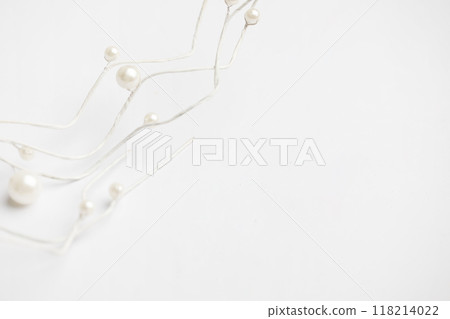 Christmas twig with white pearls decoration border on white background with copy space 118214022