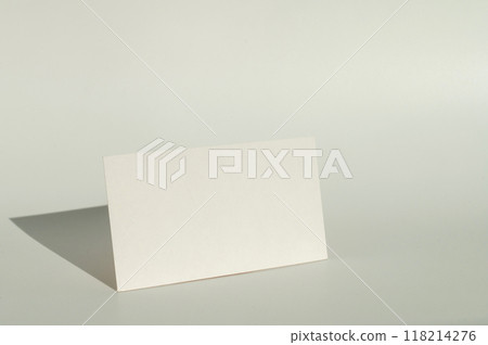 White blank business card on brown paper background with soft shadow. White blank business card on brown paper background with soft shadow. 118214276