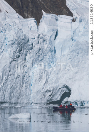 Tourists observing a glacier on the Antarctica, Paradise bay, Antartic Peninsula. Tourists observing a glacier on the Antarctica, Paradise bay, Antartic Peninsula. 118214620
