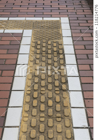 A sidewalk with a braille block A sidewalk with a braille block 118214776