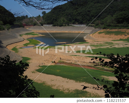 A pond where the water level has dropped significantly 118215537