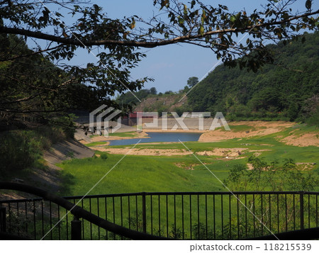 A pond where the water level has dropped significantly A pond where the water level has dropped significantly 118215539