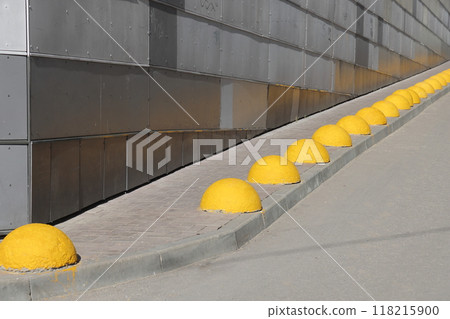 Lawn protection. Group of the concrete traffic limiters in the street. 118215900