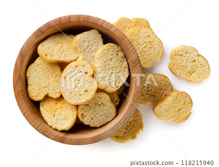 Croutons baguettes in a wooden plate close-up on a white background. Isolated Croutons baguettes in a wooden plate close-up on a white background. Isolated 118215940
