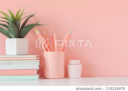 Peach color wall and home office desk with supplies, pencils, pens, boxes, plant pot. Creative stylish minimal workspace. Contemporary flat white work tabletop for product display montage. Blank space Peach color wall and home office desk with supplies, pencils, pens, boxes, plant pot. Creative stylish minimal workspace. Contemporary flat white work tabletop for product display montage. Blank space 118216976