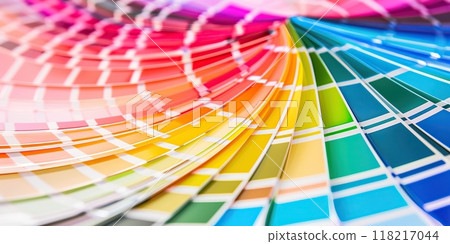 Color guide close up. Assortment of colors for design. Colors palette fan on a white concrete wall background. Graphic designer chooses colors from the color palette guide. Coloured swatches catalogue 118217044