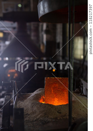 Ferrous metal billet is melted in an induction furnace closeup Ferrous metal billet is melted in an induction furnace closeup 118217397