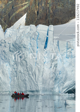 Tourists observing a glacier on the Antarctica, Paradise bay, Antartic Peninsula. 118217492