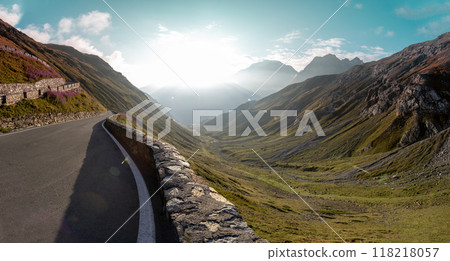 Motorbiker riding in Italian Alps during sunrise, dramatic sky. Travel and freedom, outdoor activities Motorbiker riding in Italian Alps during sunrise, dramatic sky. Travel and freedom, outdoor activities 118218057
